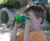 A young boy looking through binoculars outdoors. Náhľad obrázku produktu