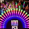 A group of people at a party holding up colorful LED foam sticks. Náhled obrázku produktu