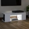 A white TV stand with a black electronic device on top and books inside. Náhľad obrázku produktu