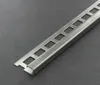 A close-up shot of a metal tile trim profile on a dark gray surface. Produktbild-Vorschau