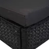 A close-up view of the corner of a black rattan chair with a dark gray cushion. Produktbild-Vorschau