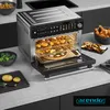 A modern kitchen countertop with an air fryer oven in the center, filled with various cooked foods like pizza, fries, and chicken. Produktbild-Vorschau