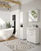 A modern bathroom with a freestanding bathtub, a vanity with a sink, a tall cabinet, and a radiator. Podgląd zdjęcia produktu