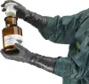 A person wearing protective gear and gloves is holding a chemical bottle. Produktbild-Vorschau