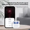 A smartphone displaying an AirPods connection prompt is placed next to a charging case with blue AirPods inside, on a wooden table. Voir les images du produit