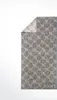 A folded grey towel with a pattern and the brand logo. Produktbild-Vorschau