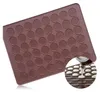 A brown silicone baking mat with circular indentations for making small pastries, with a close-up inset showing a piping bag filling the indentations. Podgląd zdjęcia produktu