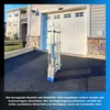 A folded ladder is placed on a driveway in front of a garage door. Náhľad obrázku produktu