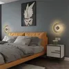 A bedroom scene with a bed, nightstand, and wall art, featuring a wall clock. Produktbild-Vorschau