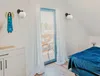 A bedroom with a bed, window, and furniture. Podgląd zdjęcia produktu