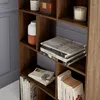 A close-up view of a wooden bookshelf with various items on its shelves. Produktbild-Vorschau