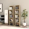 Two tall, narrow CD shelves filled with CDs and some books, placed next to a white speaker and a potted plant. Podgląd zdjęcia produktu