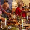 A family is gathered around a table for a meal, with a roasted turkey and various side dishes. LED candles are placed on the table as decoration. Produktbild-Vorschau