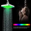 A woman is showering under a LED shower head that is changing colors. Produktbild-Vorschau