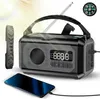 A black and gray emergency radio with a compass and a smartphone charging next to it, with light rays in the background. Náhled obrázku produktu