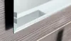 A close-up view of a mirror with a wooden frame and a white interior. Náhľad obrázku produktu