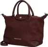 A studio shot of a burgundy handbag. Produktbild-Vorschau