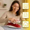 A woman is ironing a shirt with a red and white travel iron. There are three yellow graphic overlays on the right side of the image. Produktbild-Vorschau