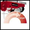 A close-up view of a red electric hoist with a graphic overlay indicating a stop function. Náhľad obrázku produktu