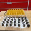 A yellow silicone mold for baking cookies in the shape of beehives or wasp nests, with finished cookies dusted with powdered sugar arranged in front of it. Náhled obrázku produktu