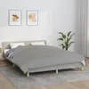 A bed with a gray blanket is shown in a room with two framed pictures on the wall and a plant. Podgląd zdjęcia produktu