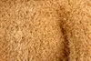 A close-up view of a textured, fuzzy material, likely a plush toy. Voir les images du produit