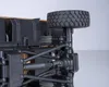 Close-up view of the underside of a toy vehicle's suspension and wheel assembly. Produktbild-Vorschau