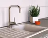 A kitchen sink with a faucet, a potted plant, and a small bowl. Náhled obrázku produktu