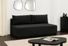 A modern living room with a black sofa, coffee table, and decorative items. Voir les images du produit