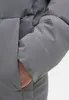 Close-up of a person's arm inside a gray puffer jacket sleeve. Produktbild-Vorschau