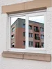 Reflection of a building in a window covered with reflective film. Produktbild-Vorschau