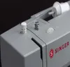 A close-up view of the top of a gray Singer sewing machine, showing the thread spool, tension dial, and the Singer logo. Náhled obrázku produktu
