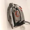 A Russell Hobbs iron is shown leaning against a white wall. Podgląd zdjęcia produktu