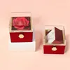 Two gift boxes, one with a rose and the other with a necklace, are displayed against a light pink background. Anteprima dell’immagine prodotto