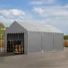 A gray tent structure with pallets and a pallet jack inside, set up outdoors on a gravel surface. Podgląd zdjęcia produktu