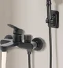 A black bathroom faucet with water flowing from the spout, mounted on a light-colored wall. Produktbild-Vorschau