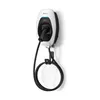 A white and black electric vehicle charging station mounted on a white wall, with its charging cable neatly coiled on a holder. Podgląd zdjęcia produktu