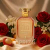 A perfume bottle is displayed with roses, lychee, and jasmine flowers on a satin cloth. Náhled obrázku produktu