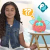 A young girl is meditating next to a Furby toy, with a thought bubble above her head containing question marks. Anteprima dell’immagine prodotto