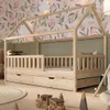 A child's bedroom with a wooden house bed, decorated with floral wallpaper and green wall paint. Produktbild-Vorschau