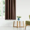 A brown curtain hangs in front of a window, with a small table and a chair in the foreground. Podgląd zdjęcia produktu