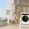 A laundry room with a washing machine and a drying rack with clothes. Produktbild-Vorschau