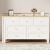 A white dresser with a wooden top and gold knobs, decorated with a vase of flowers, a book, and a calendar. Podgląd zdjęcia produktu