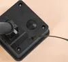 A close-up view of the back of a black solar light fixture, showing a wire extending from a small opening. Produktbild-Vorschau