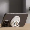 A smartphone with a MagSafe accessory attached, resting on a wooden surface. Produktbild-Vorschau