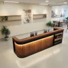 A modern reception desk with integrated LED lighting, computers, and decorative shelving. Produktbild-Vorschau