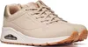 A single beige Skechers Uno Shimmer Away sneaker is shown against a white background. Produktbild-Vorschau