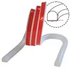A white silicone shower threshold strip with red adhesive tape is shown against a white background. A close-up diagram of the strip's cross-section with dimensions is in the upper right corner. Voir les images du produit