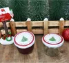 Christmas-themed jars and decorations on a wooden surface with miniature Christmas trees in the background. Produktbild-Vorschau