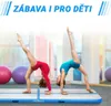 Two young girls are doing gymnastics on an inflatable air mat. Podgląd zdjęcia produktu